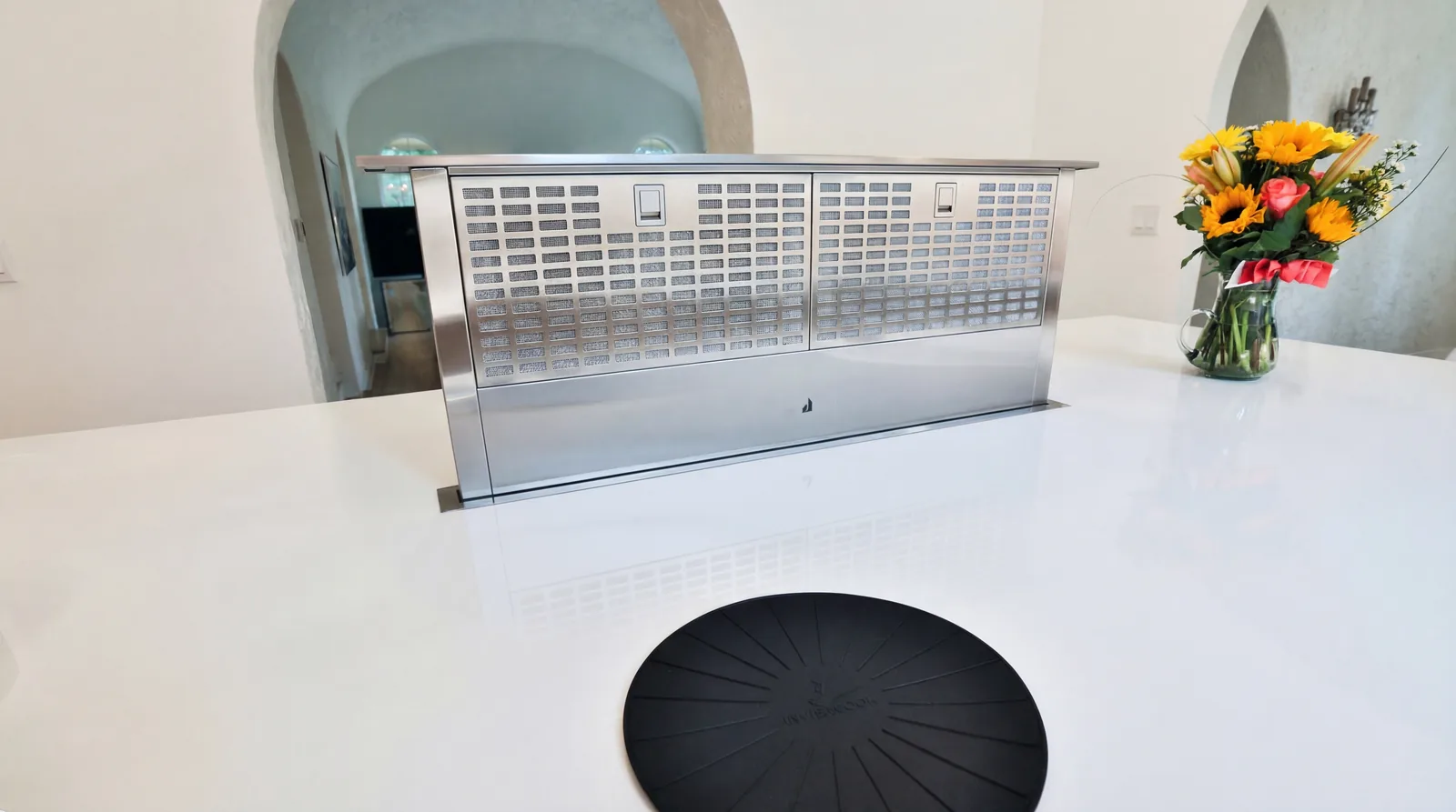 Pop-up downdraft vent raised from the porcelain island