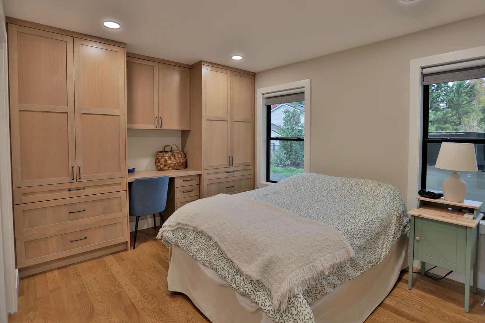 Built-in white oak wardrobe and desk in the ADU bedroom