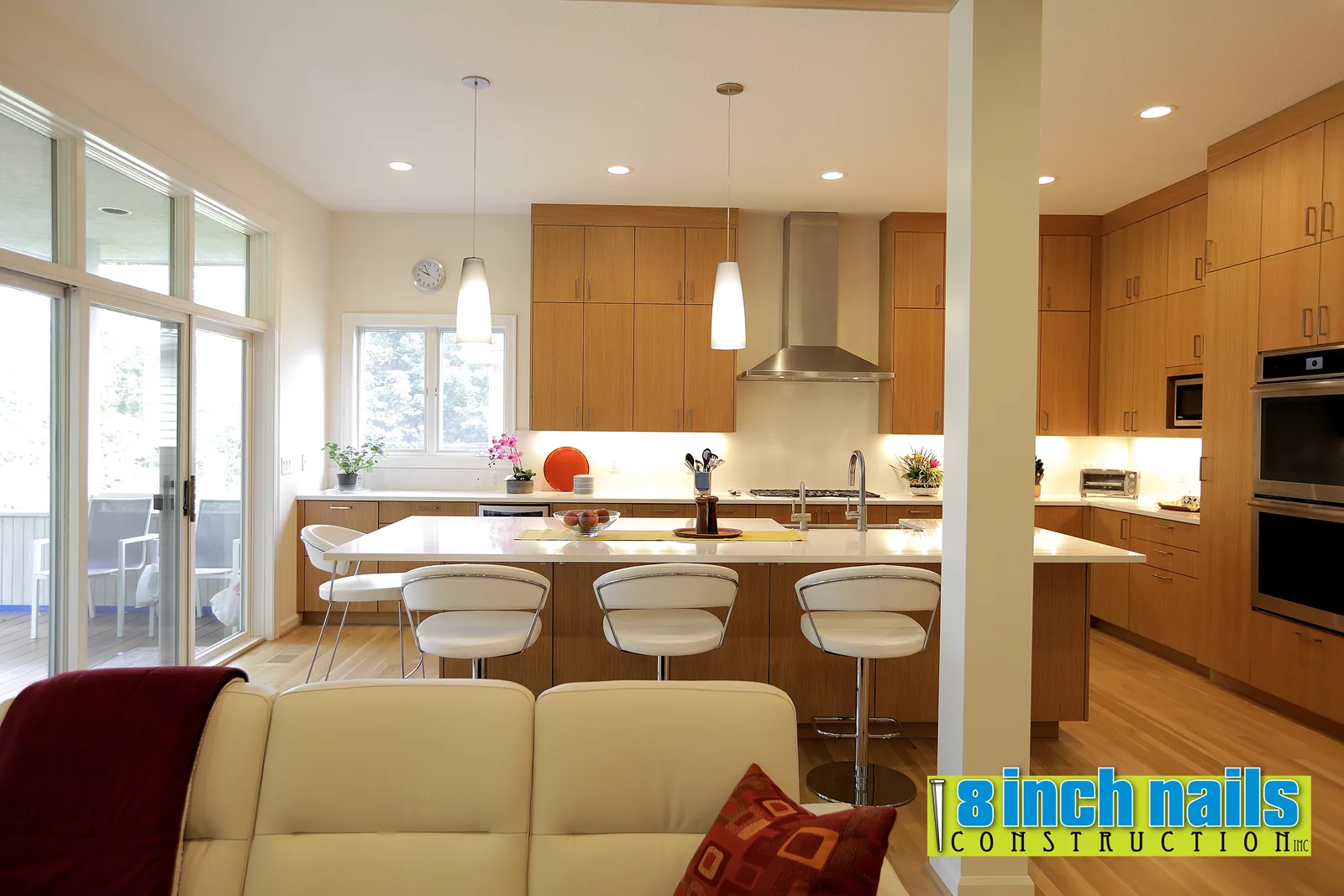 NW Portland kitchen in rift white oak with quartz counters and a stainless chimney hood