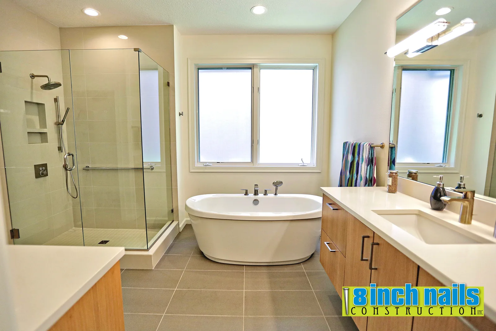 Primary bath with a freestanding tub and a frameless corner shower
